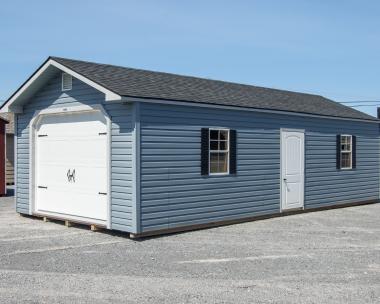 14x32 Peak Single-Car Garage With Twilight Blue Vinyl Siding, White Overhead Door, Black Shutters, and Shingle Roof